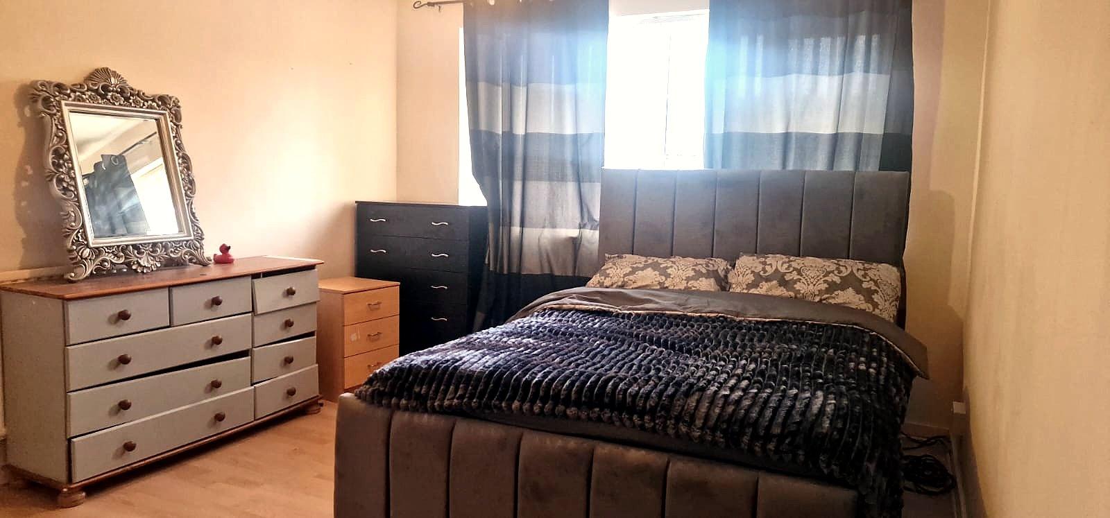 Bedroom with chest of drawers and ornate mirror