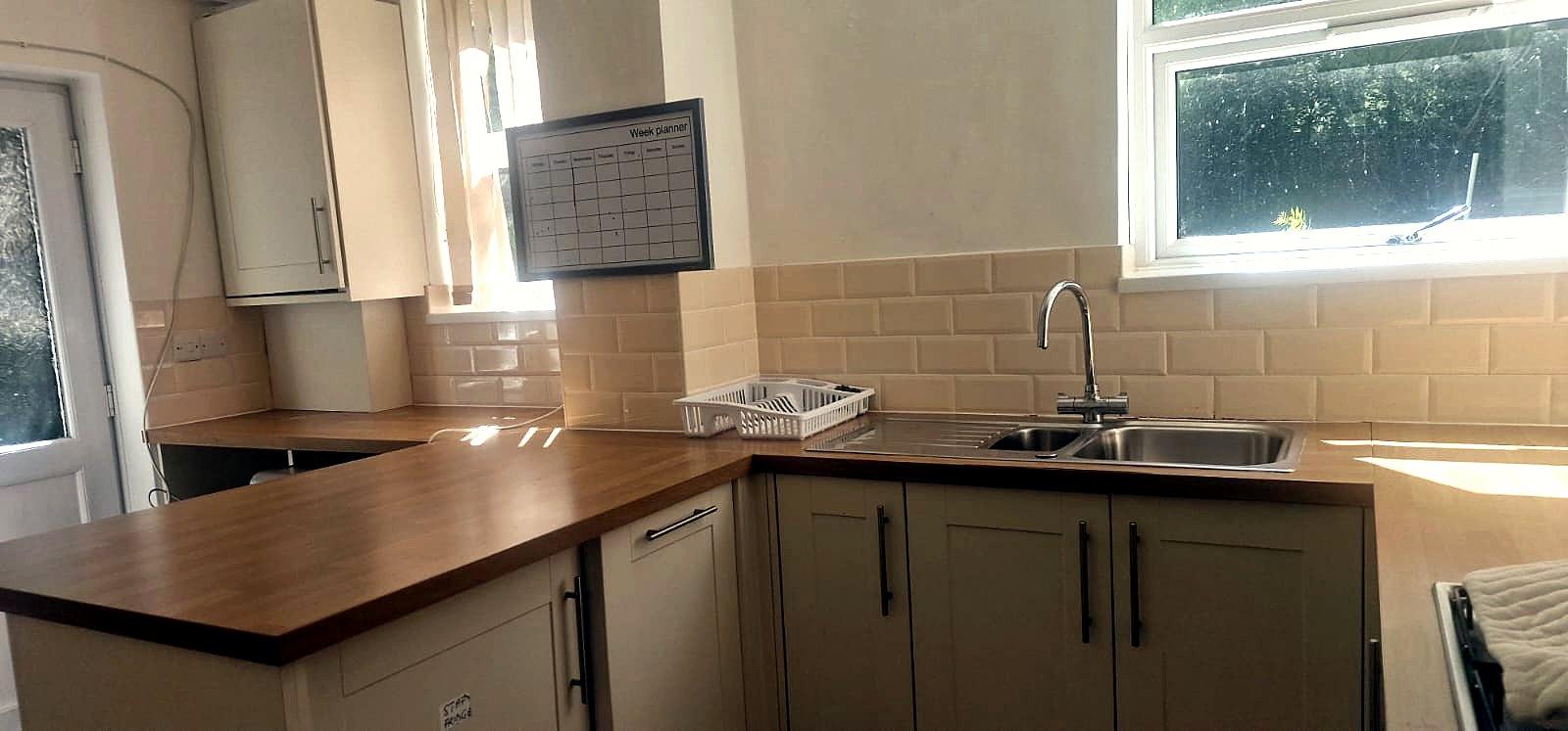 Kitchen with oak worktops and sink beneath the window