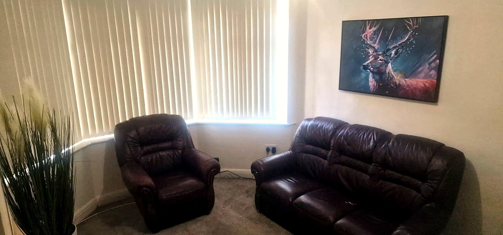Lounge with leather sofas and a bay window